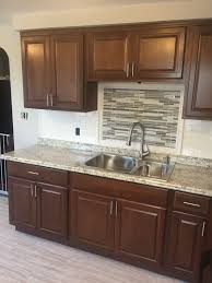 Hampton Bay Cognac Kitchen Cabinets With Subway Tile Backsplash And Mosaic Accent Medalli Kitchen Cabinets Pictures Best Countertops Kitchen Cabinet Dimensions