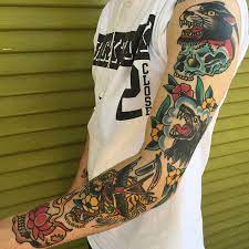 This tattoo includes black and grey inked traditional intertwined pattern with a man holding a bow and arrow ready to aim his shot. Traditional Sleeve Tattoo Tattoogrid Net