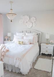 Sophisticated primary bedroom boasts a white coffered ceiling and pink full wainscoted accent wall decorated with gold gallery frames. Lovely Light Pink And Gold Bedroom