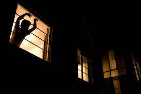 Night Windows Low Angle View Of A Man Looking Out A Night Window In Buenos Aires Argentina
