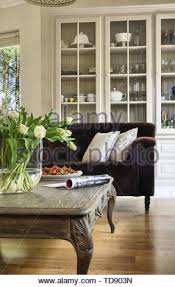 40l x 24w x 18t. White Sofa With Dark Pillows And Patterned Blankets Standing In Bright Living Room Interior With Green Armchair And Fresh Plants Stock Photo Alamy