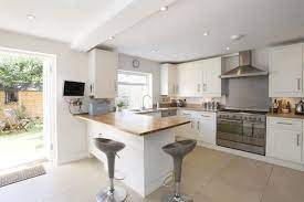 A pale green paint color blends the small kitchen and dining area of this jungalow, by justina blakeney, especially when paired with the moroccan clay tile backsplash and ombré dining bar. Small Kitchen Diners Google Search Small Kitchen Diner Kitchen Dining Living Open Plan Kitchen Dining