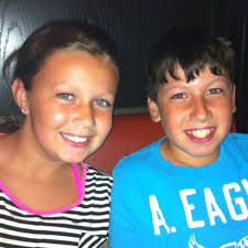 What age group should a 13-year-old softball player participate in?