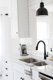 In this beautiful black and white farmhouse kitchen, the space is softened with greige tile and walls. Kitchen Backsplash Image Ideas Kitchenbacksplashpictures Kitchen Backsplash Ideas South Africa Kitchen Black Kitchen Faucets Trendy Kitchen Kitchen Hardware