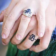 This Couple Is Nothing If Not Sure Of Their Undying Love Wedding Band Tattoo Married Couple Tattoos Engagement Tattoos