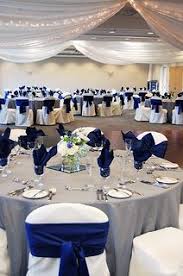 Black White And Royal Blue Wedding Theme Royal Blue Napkins And Sashes Against White Chair Covers And Gray Linen Plus Ceil Wedding Reception Decorations Wedding Reception Chairs Wedding Centerpieces