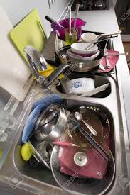 dirty dishes in a kitchen sink. stock
