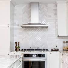 Wooden hoods look great against white tile or next to white cabinets. 2 In 2021 Herringbone Backsplash Kitchen White Subway Tiles Kitchen Backsplash Kitchen Design Small