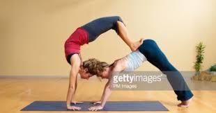 2 Women Performing Double Yoga Pose Downward Dog And Scorpion Yoga Poses For Beginners Couples Yoga Yoga Poses