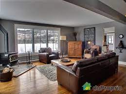 This sofa is deep and dark and works well against the backdrop of a dark wall and cooler grey living room flooring. Astounding Useful Tips Basement Remodeling Hallways Basement Remodeling On A Budget Craft Rooms Brown Furniture Living Room Brown Living Room Living Room Grey
