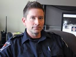 Kingston Police officer at home in a cruiser or a Jeep