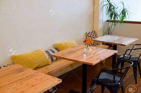 Coffee tables, dining tables, benches, and more can be customized according to size, color, style — and of course industrial vintage style coffee table, made from reclaimed wood and steel thats over 100 years old. Bench Seating At A Coffee Shop Restaurant With Small Cafe Tables Stock Photo Picture And Royalty Free Image Image 66548640