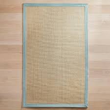 Woven of cotton chenille and natural jute, this chevron flatweave offers subtle detail and soft feel underfoot, along with a contrast border that defines your space. Alona Maui Blue Border Jute Rug