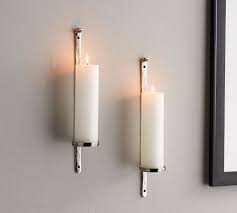 Add a dynamic touch to your decor with this unique scroll shape with hand both pieces carry a silvery finish and a platform with a spike that holds votive or tapered candles, making them suitable fixtures in eclectic interiors. Artisanal Wall Mount Candleholder Silver Silver Candle Sconces Candle Holders Wall Candle Holders