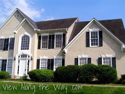 A neighborhood filled with beige nondescript houses isn't very appealing for the eye. House Exterior Beige With Black Shutters And Black Roof Beige House Exterior Black House Exterior House Exterior
