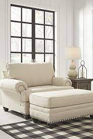 A comfortable contemporary chair of metal and white leather and a blanket for cozy reading. These Comfy Chairs Are As Pretty As They Are Cozy Comfy Chairs Living Room Chairs Chair And A Half