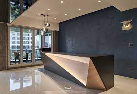 The front desk in a hotel where guests can book rooms or ask services; 1 The Shape Of The Table Office Reception Table Design Office Reception Design Reception Desk Design