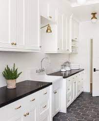 Orange color accented wall tiles cover the surface like marble. Warm White Cabinets Brass Hardware Soap Stone Or Granite Counters Visalia Ca Black Kitchen Countertops Kitchen Black Counter Black Countertops