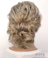 Wind the ponytail around the base of the hair tie to form the bun. 40 Creative Updos For Curly Hair