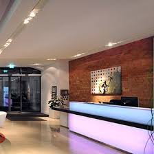 London Architects Tate Hindle Designed This Glowing Reception Desk Using Back Lit Varia Ghost With 3form Counter Design Reception Desk Counter Reception Desk