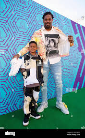 Cam Jordan, right, and son Caleb Tank arrive for the 2022 Pro Bowl