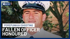 Killed Police Officer Remembered In Emotional Funeral As Hunt For Dezi  Freeman Continues