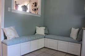 Corner dining nook is filled with a freestanding gray upholstered curved dining banquette lined with colorful silk pillows facing an oval. Diy Ikea Hack Banquette From Lidingo Cabinets Banquette Seating Banquette My Home Design