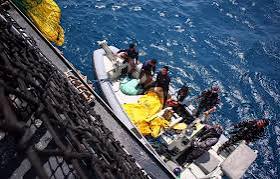 Search and rescue boats at sea looking for survivors of the sunken ferry.