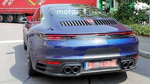 Soft focus, motion blur summer cloudscape background. 2019 Porsche 911 Caught Uncovered And Looking Beautiful In Blue