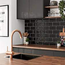 Neutral colored countertops and wooden open shelving keep this kitchen feeling natural. Wickes Metro Black Ceramic Wall Tile 200 X 100mm Wickes Co Uk