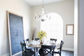 This curved back upholstered dining chair does so much more than provide seating in the dining room. Round Gray Table With Black Wood X Back Dining Chairs Transitional Dining Room
