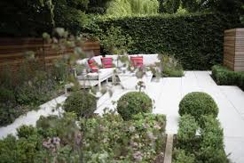 Outdoor Relaxing And Entertaining Area With Fire Table Cedar Panelling And Clipped Box Balls In Tranquil Garden I Garden Design Outdoor Outdoor Furniture Sets