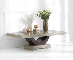 A coffee table with storage can help reduce clutter by adding extra space for remotes, throw pillows, magazines, and toys. Raphael Brown Marble Coffee Table Thomas Brown Furnishings