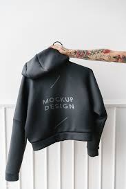 Download Premium Psd Of Tattooed Woman Holding A Gray Hoodie Mockup 1215336 Hoodie Mockup Grey Hoodie Shirt Mockup