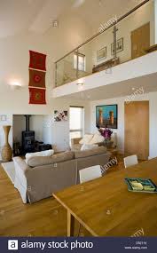 An Open Plan Living Dining Room With A High Ceiling And A Small Mezzanine Stock Pho High Ceiling Living Room Open Plan Kitchen Living Room Living Room Flooring