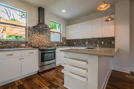 Stone backsplash kitchens for style and durability. Bright Modern Kitchen With Natural Stone Backsplash Stainless Steel Range Hood And Sleek White Cabinets Hgtv