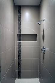 The Porcelain Tile Of This Sleek Shower Surrounds A Glass Accent Tile Stripe And Built In Niche To Store Sh Shower Tile Bathroom Remodel Shower Bathroom Design