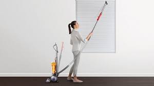 Woman Using Dyson Light Ball Instant Release High Reach Wand To Clean Hard To Reach Place Ball Lights Clean Dyson Vacuum Dyson