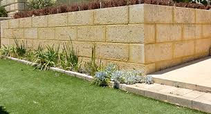 Design ideas for a large contemporary back garden in glasgow with a retaining wall and natural stone paving. 5 Limestone Retaining Wall Ideas For Your Garden Remastone Blog