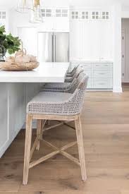 Gorgeous White And Gray Kitchen Features Candelabra Home Tapestry Counter Stools Placed At A Light Gray Island Finished Wit Home Remodeling Home House Interior