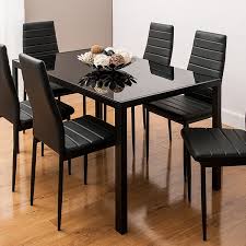 The trendy metal dining table with stack chairs will give your dining room or bar decor a refreshing rustic feel with its wood features. Glass All Black Dining Table Set With 6 Chairs