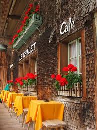 Switzerland Travel Inspiration Le Chalet Cafe In Gruyeres France Colorful Cafe Outdoor Cafe Cafe Design