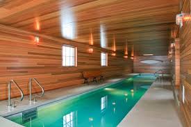 Indoor Lap Pool Modern Lights Long Pool Poolside Bench Wooden Walls Wooden Ceiling Of Indoor P Indoor Pool Design Indoor Swimming Pool Design Small Indoor Pool