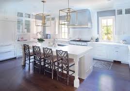 White Kitchen Island With Brown Bamboo Dining Chairs And Square Brass Lanterns Transitional Kitchen Home Country Cottage Kitchen Bamboo Dining Chairs