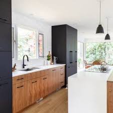 Black And Light Wood Kitchen Cabinets Black And Light Wood Kitchen With White Countertops And Matte Black Accents Mattebla White Modern Kitchen Kitchen Cabinet Styles Mid Century Modern Kitchen