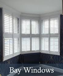Old wooden window shutters are closed and are located closeup on an old plastered wall for an abstract. Shutters For Bay Windows By Shutter Master Of London