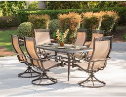 Get free shipping on qualified patio dining sets or buy online pick up in store today in the the set seats four in stylish comfort with its swivel dining chairs and round glass top table. Amazon Com Hanover Mandn7pcsw 6 Chairs And Rectangle Cast Aluminum Table Brushed Bronz Manor 7 Piece Outdoor Patio Dining Set 6 Sling Swivel Rocker Tan Garden Outdoor
