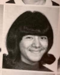 Please collect this photo of my sister. She has brown eyes and dark hair.