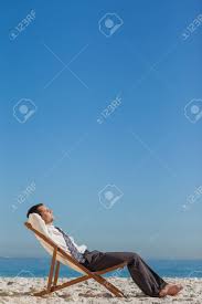 Young Businessman Resting On His Deck Chair On The Beach Photo Stock Photos Couple Beach