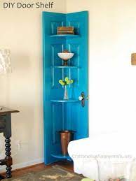 Cover an old door with decorative hanging bars for towels in the bathroom, use long hooks for a coat rack in an entryway, or use smaller teacup hooks (perhaps on a smaller door) to hang jewelry. Old Door To Corner Shelf Home And Garden Craftgossip Com Diy Door Door Shelf Diy Furniture